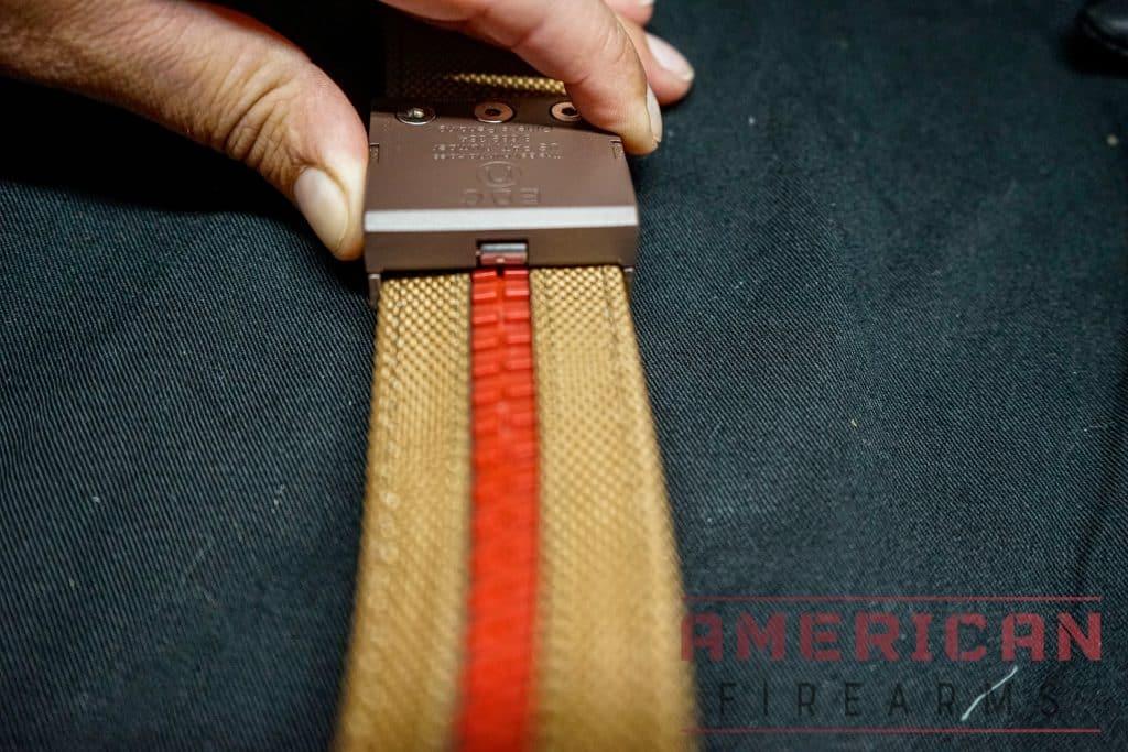Pushing the bottom release button allows you to slide the buckle along the continuum of teeth, enabling you to find a perfect fit or adjust quickly on the fly.