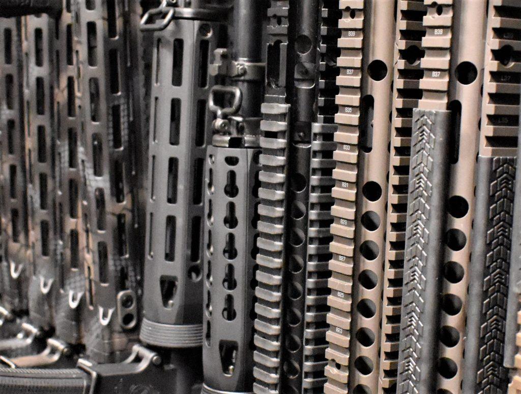 A rack full of KeyMod, M-LOK, and Quad Rail mounted ARs.