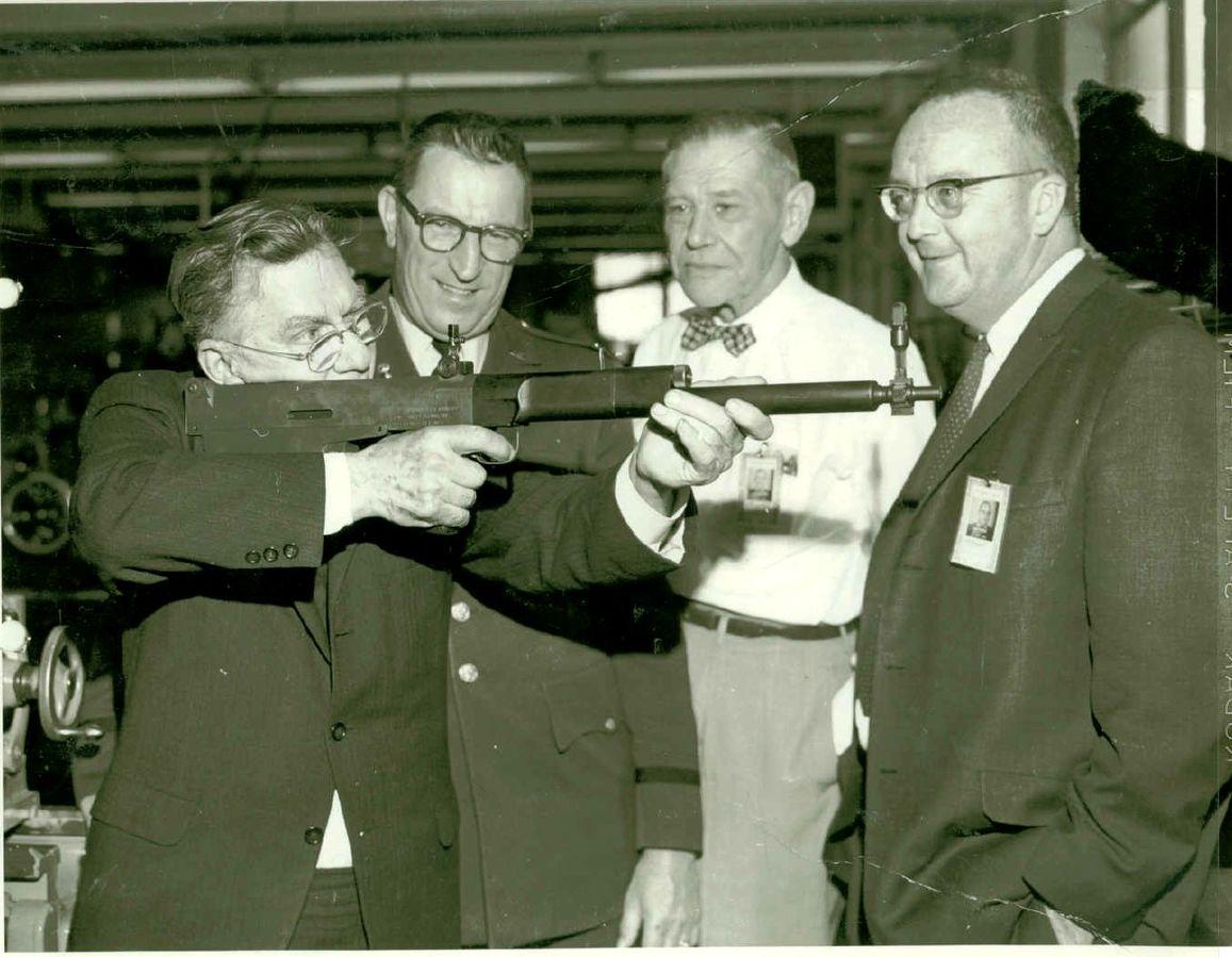 John C. Garand shouldering his final advanced rifle design, the T31 Bullpup via Wikimedia Commons