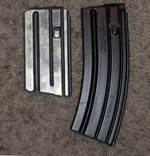 Two STANAG compatible magazines. the Colt 20-round magazine (left), and a 30-round H&K magazine (right)