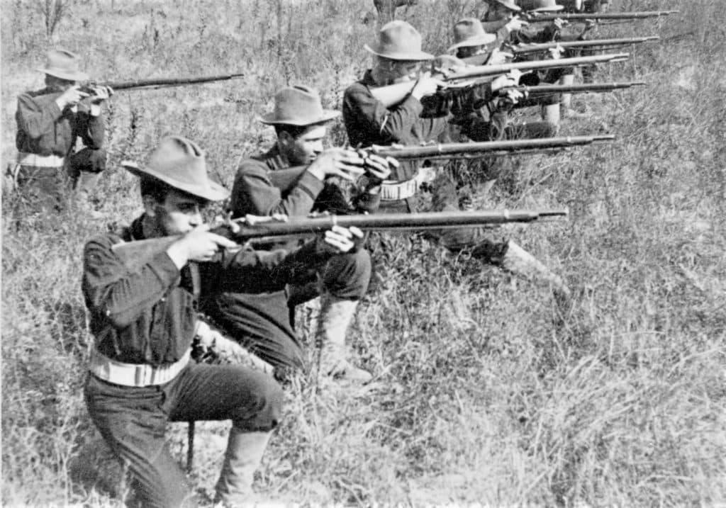 No two alike! As exemplified by these members of the 16th Pennsylvania Volunteers kneeling, with their obsolete Springfield Trapdoor rifles raised during the Spanish-American War, peacetime marksmanship training was lacking at the time. (Photo: Library of Congress)