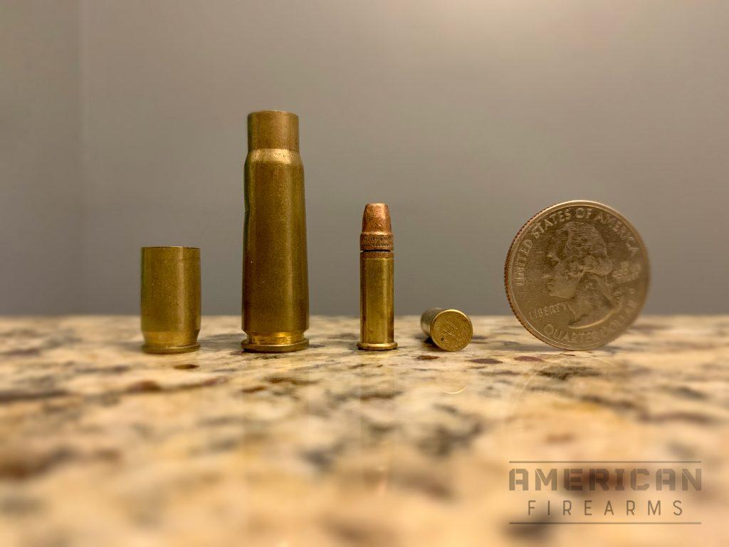 Here you can see the diminutive .22LR (center) relative to spent .45ACP and 7.62x39 cartridges (as well as the seemingly massive U.S. quarter.)