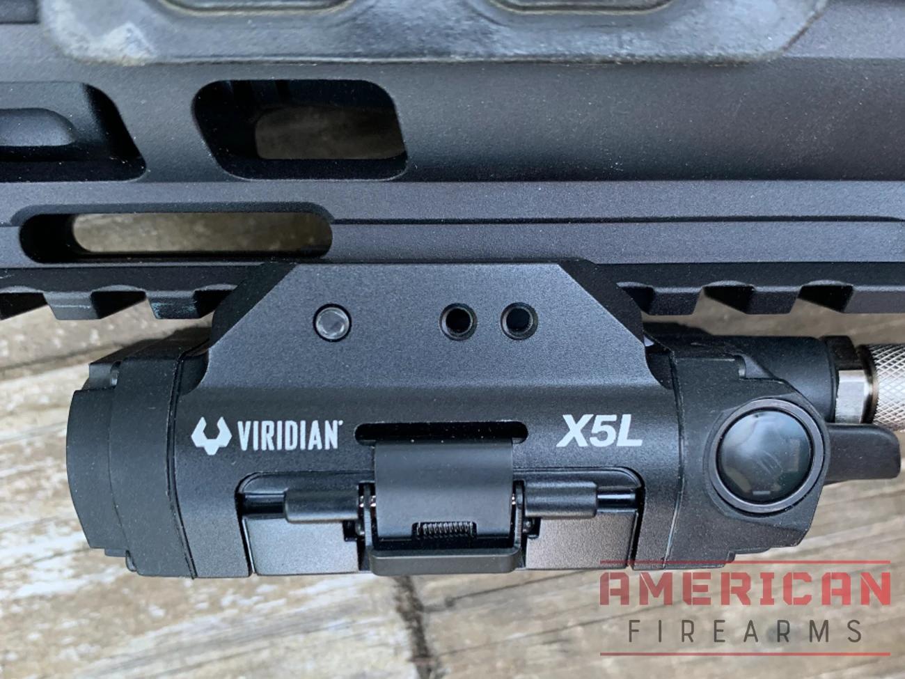 The X5L uses a Pic rail attachment clamp, which is secured with a screw. While not as convenient a throw lever, it's also more secure.