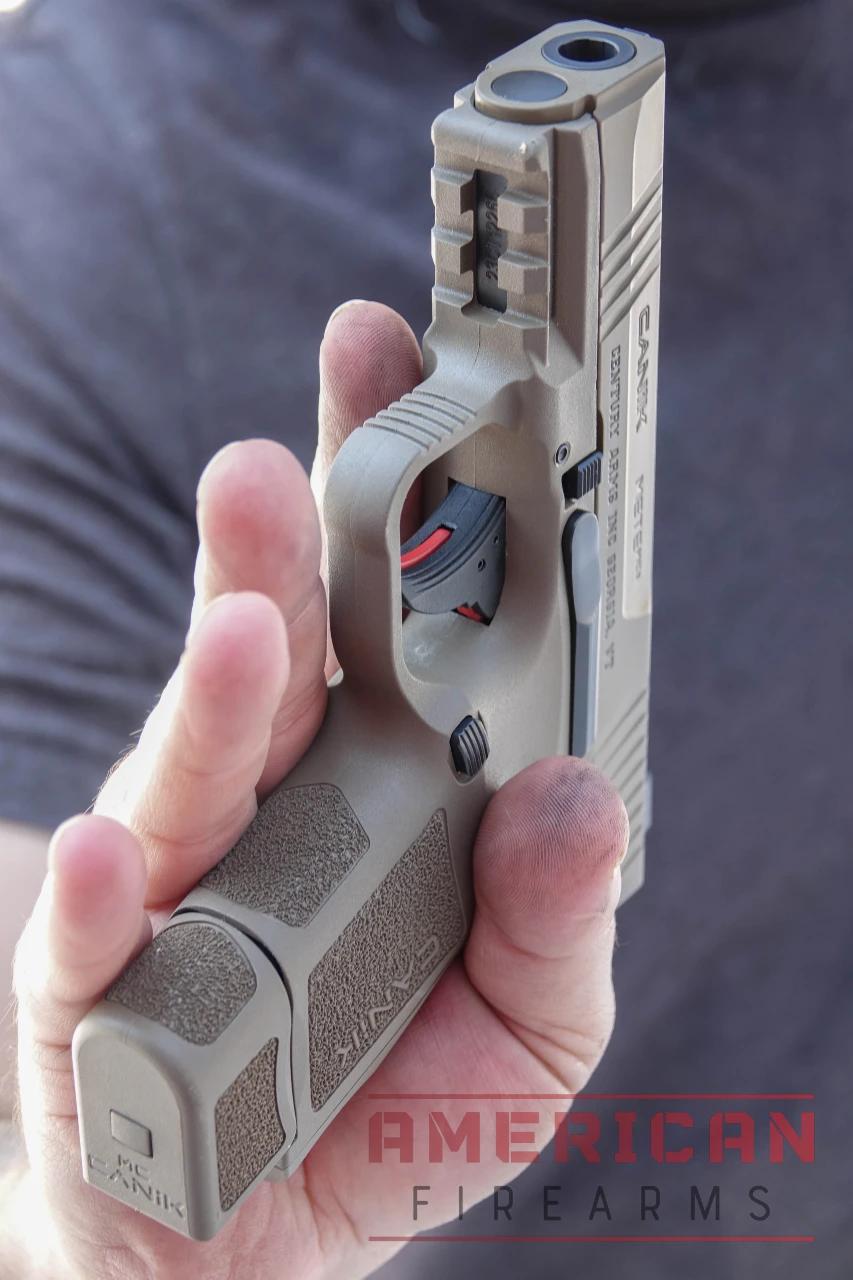 The METE MC9 trigger is unique, with a textured, rounded shoe and red blade safety.